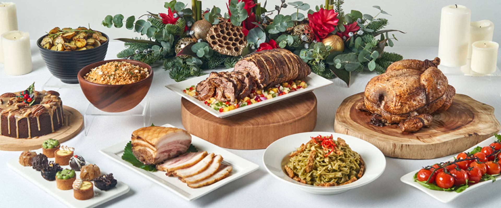 Christmas turkey, roast beef, tomato, potatoes on wooden boards white plates
