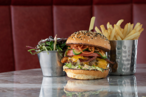 A beef burger with fries and salad on the side. The Mayfair Combo by Burger & Lobster, delivered islandwide in Singapore powered by Oddle. For sharing platter delivery Singapore.