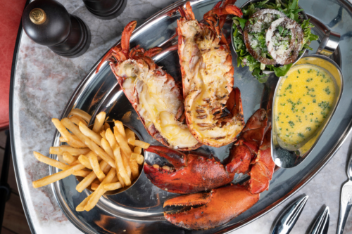 A platter of lobsters, fries, salad and a butter gravy. 1.5lbs Lobster Combo from Burger & Lobster, delivered islandwide in Singapore powered by Oddle. For sharing platter delivery Singapore.