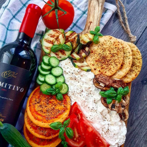 A board of burrata cheese, cucumber slices, and San Marzano tomatoes for sharing. The Truffle Burrata & Antipasto Board from Burrata Bar, delivered islandwide in Singapore powered by Oddle.