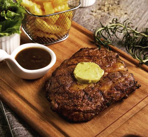 A slab of ribeye steak topped with butter delivered islandwide in Singapore powered by Oddle