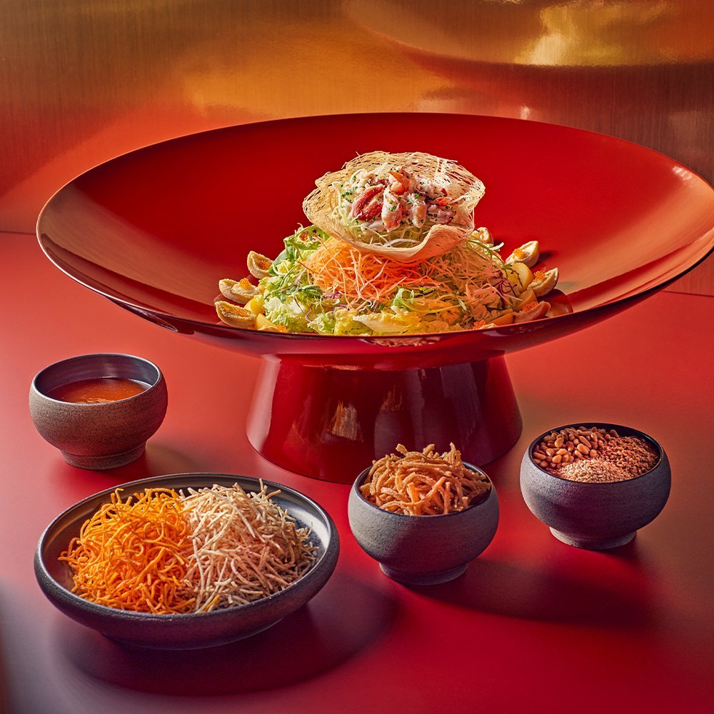 The Auspicious Abundance Lo Hei from Min Jiang at Dempsey is a yusheng featuring crab, romaine lettuce, wild arugula, yellow frisee, pickled ginger, sweet peaches, sweet potato strips, and is delivered islandwide in Singapore powered by Oddle
