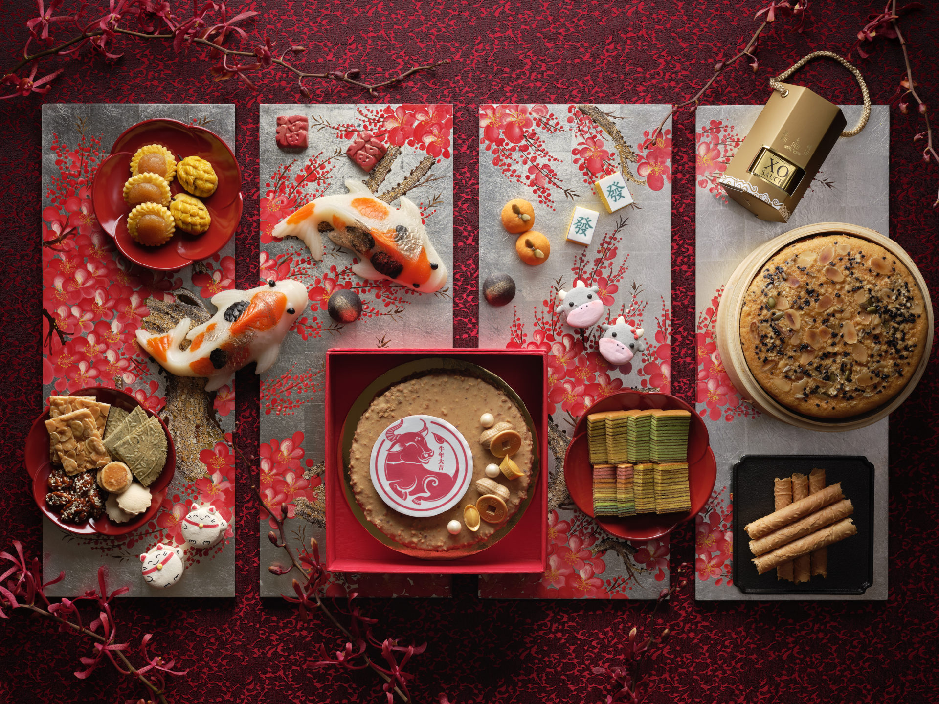 Pan Pacific Singapore's display of Chinese New Year Goodies including koi-shaped nian gao, animal zodiac macarons, pineapple tarts, bak kwa, kueh lapis and love letters. for Chinese New Year 2021. Delivery available islandwide in Singapore, powered by Oddle.